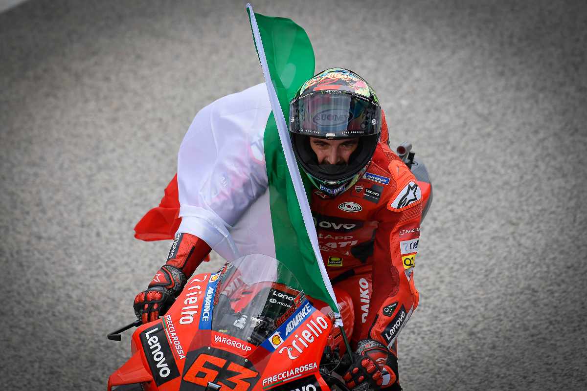 Pecco Bagnaia sventola la bandiera italiana dopo la vittoria al Gran Premio di San Marino di MotoGP 2021 a Misano Adriatico